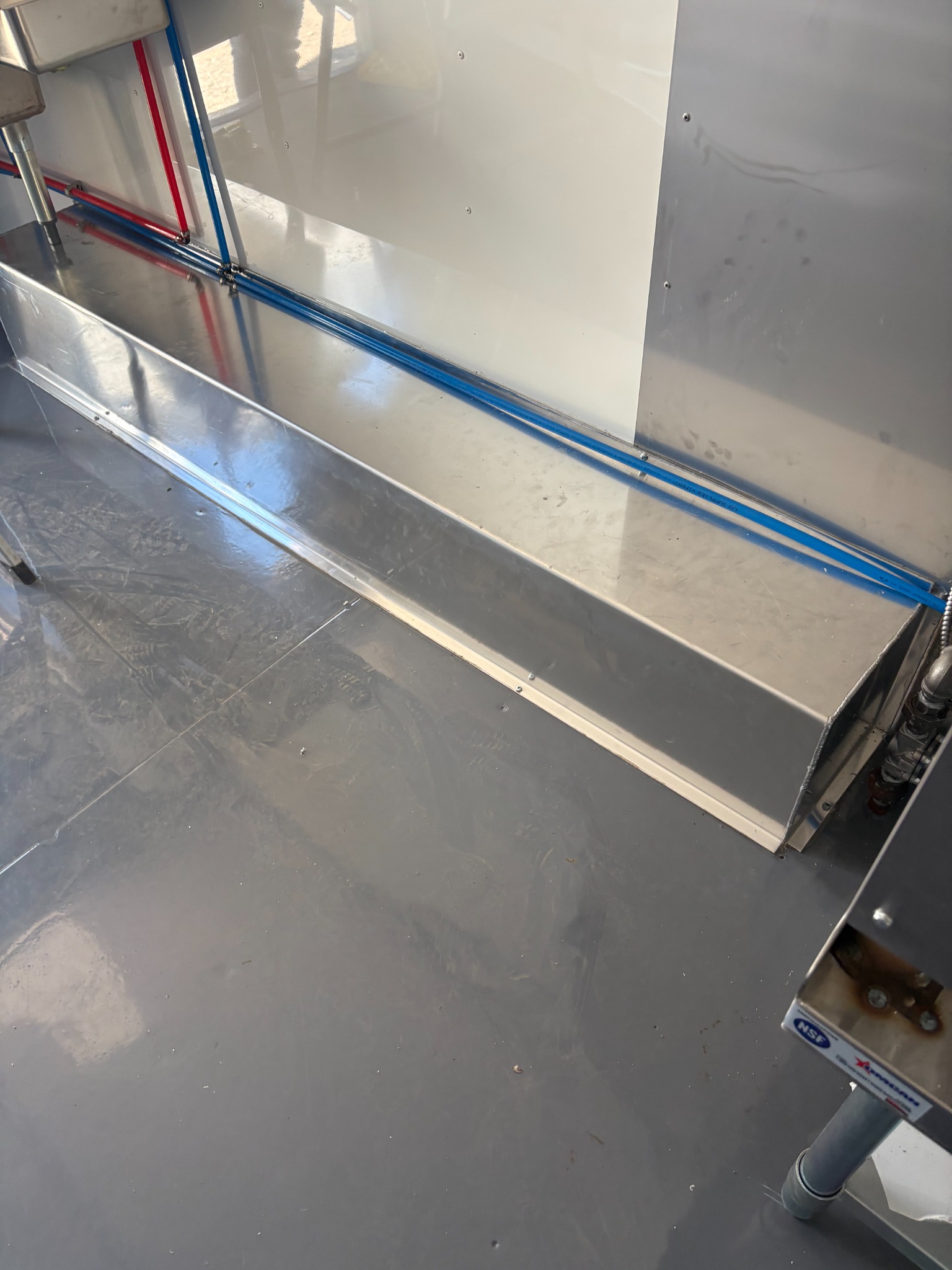 Stainless work surface beside the trailer floor